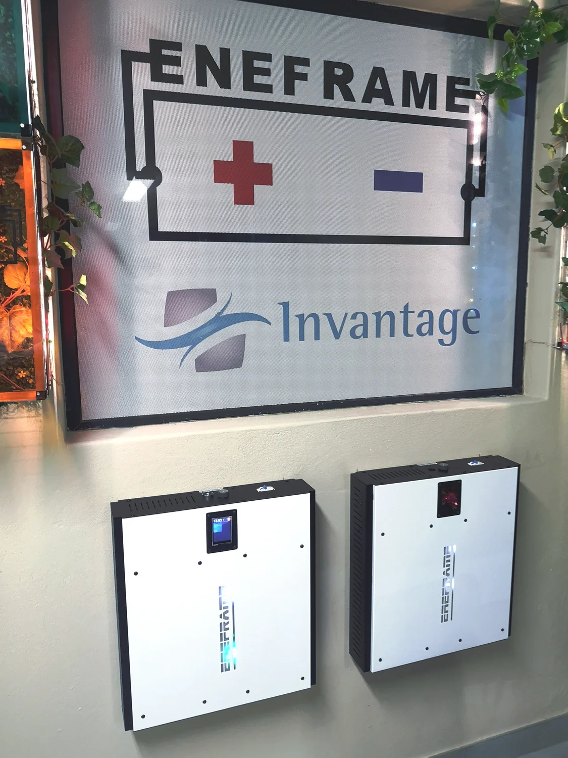 EneFrame batteries installed beneath the EneFrame sign at the local premises